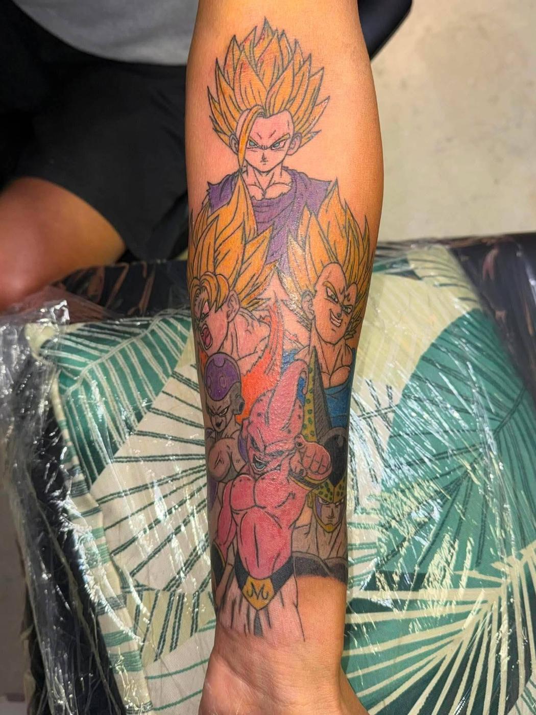 A full-color anime character piece running the length of a forearm.